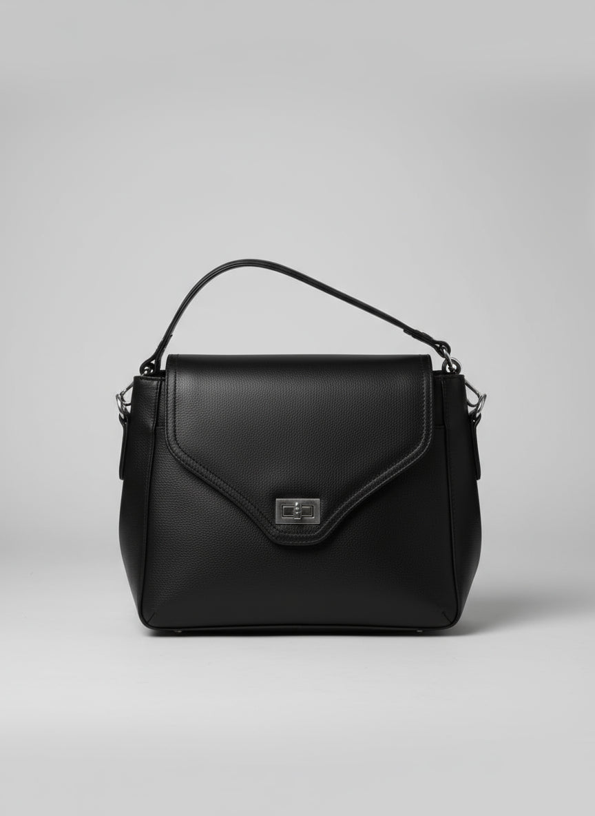 Black leather handbag on a textured surface